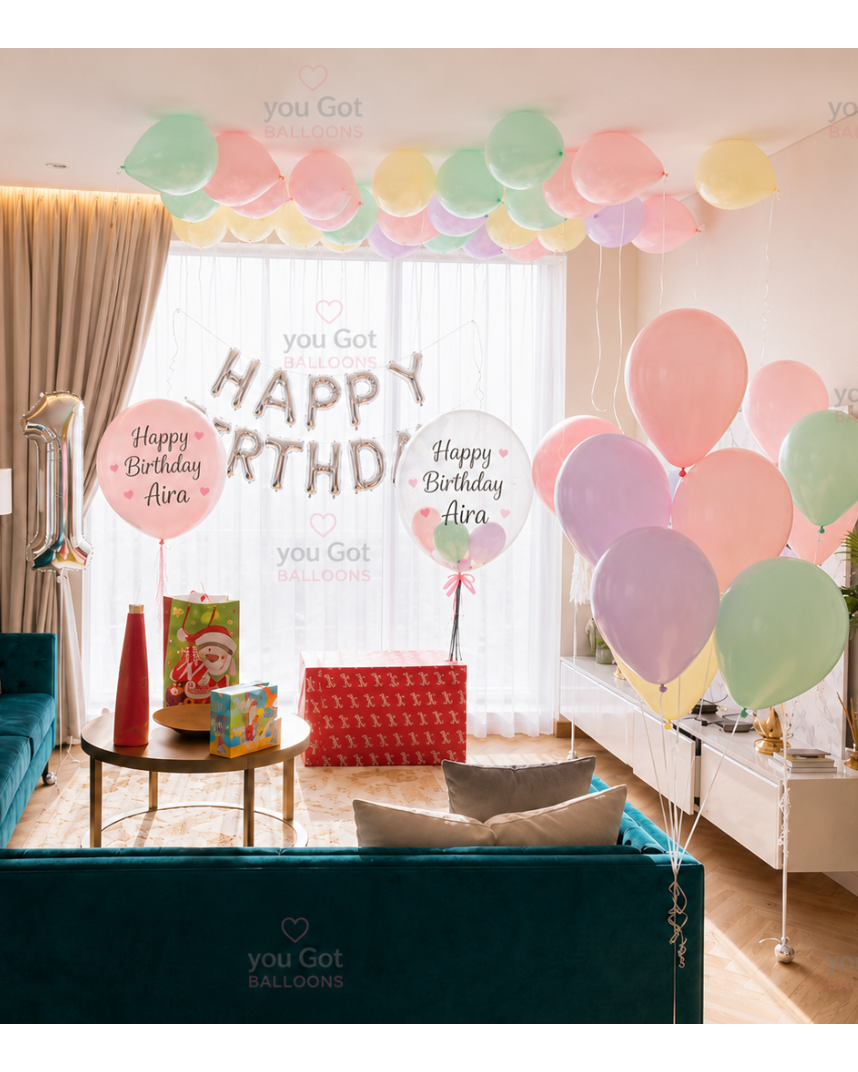1st birthday pastel balloon setup with customized bubble balloons and birthday banner in Dubai