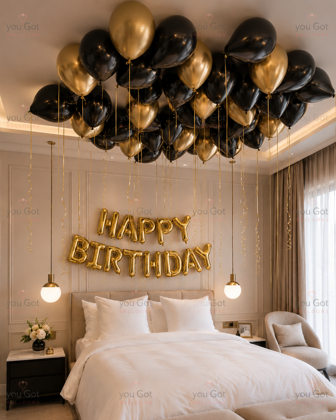 Black and gold ceiling balloon birthday setup with gold Happy Birthday backdrop in Dubai