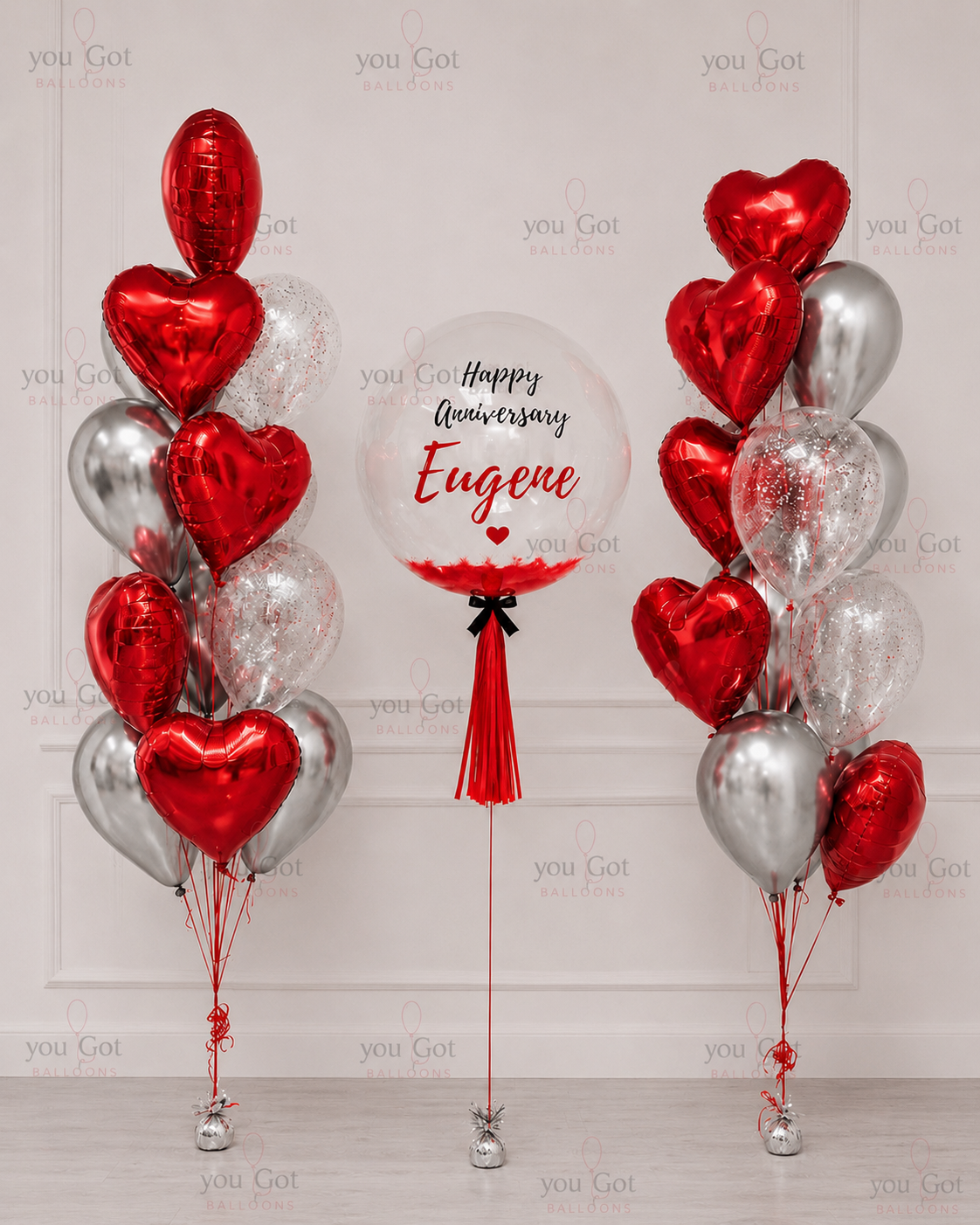 Customized balloon bouquet with red hearts feathers and personalized bubble in Dubai