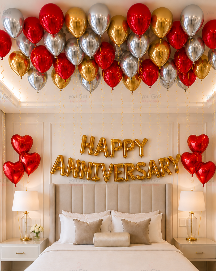 Decorated bedroom with balloons spelling 'Happy Anniversary' above a bed.
